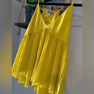 Bright neon yellow tank with great movement on the lower half of the shirt.